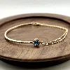97394118 bracelet demi jonc centré d'une pierre bleue et entournée des oxydes l18 cm