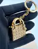 bijou de sac/porte-clés christian dior lady dior en métal doré, motif cannage