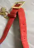 ceinture vintage yves saint laurent en cuir suédé rouge avec pendentif soleil et coeur, boucle martelée dorée taille 85/34