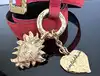 ceinture vintage yves saint laurent en cuir suédé rouge avec pendentif soleil et coeur, boucle martelée dorée taille 85/34