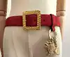 ceinture vintage yves saint laurent en cuir suédé rouge avec pendentif soleil et coeur, boucle martelée dorée taille 85/34