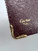 porte-cartes cartier must en cuir bordeaux avec finition dorée