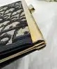 porte-monnaie/pochette vintage christian dior en toile jacquard beige et cuir bleu marine
