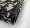 porte-monnaie/pochette vintage christian dior en toile jacquard beige et cuir bleu marine