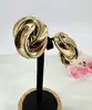 boucles d'oreilles clips dior vintage noeud tourbillon en métal doré