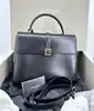 sac à main saint laurent le fermoir top handle en cuir lisse noir avec bandoulière ajustable et amovible