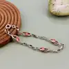 bracelet en argent orné de perles roses logées dans des maillons ajourés argent autre 6,63g