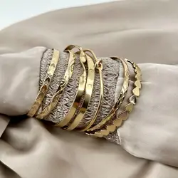 bracelet semainier 7 joncs ouverts en acier doré