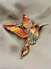 broche en émail orange motif colibri