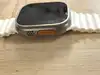 montre connectée apple watch ultra + cellular, boîtier titane 49mm avec bracelet océan blanc