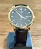 montre tissot t063610a, mouvement quartz, cadran noir, boîtier doré et bracelet en cuir noir