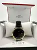 montre tissot t063610a, mouvement quartz, cadran noir, boîtier doré et bracelet en cuir noir