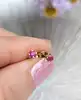 boucles d'oreilles puces chacune sertie d'un petit rubis or 750 millième (18 ct) 0,46g