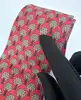 cravate hermès vintage en soie rouge à motif arbres