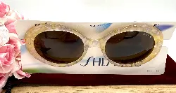 lunette de soleil shiseido verres marrons monture jaune et rose