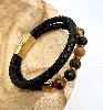 brac bracelet en cuir noir tressé, oeil de tigre d8mm, fermoir en acier doré l21 cm