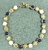 collier signé monet doré avec pierre bleu et blanche
