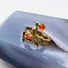 bague les néréides en forme de serpent et fleurs avec pierres orange et rouge