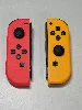 paire de joycon orange et rouge