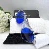lunettes de soleil chanel avec des verres bleus et la monture et les branches transparentes
