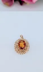 pendentif motifs ajourés centré d'un saphir orange synthétique or 750 millième (18 ct) 4,68g