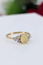 bague or centrée d'une opale épaulée de 6 petits oxydes or 750 millième (18 ct) 1,91g