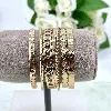 bracelet semainier 7 joncq ouverts en acier doré d6,5 cm