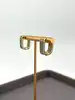 boucles d'oreilles créoles en métal doré avec ligne d'oxydes