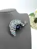 broche motif paon sertie d'oxydes bleus