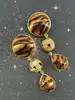 boucles d'oreilles pendantes clip vintage yves saint laurent en métal doré et pierre marron avec motif
