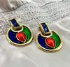 boucles d'oreilles pendqntes clip yves saint laurent en métal doré