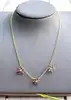 collier maille forçat orné de 3 motifs fleur chacune sertie de 6 rubis et 1 diamant or 750 millième (18 ct) 6,77g