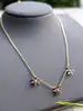 collier maille forçat orné de 3 motifs fleur chacune sertie de 6 rubis et 1 diamant or 750 millième (18 ct) 6,77g