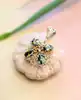 pendentif filigrane serti de 4 péridots ovales or 750 millième (18 ct) 4,35g