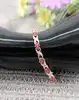 bracelet articulé en 2 ors orné des motifs fleur en rubis et motifs x chacun serti d'un diamant or 750 millième (18 ct) 10,90g