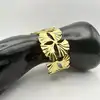 31222764 bracelet manchette motif feuille de ginkgo en acier doré