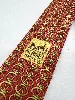 cravate hermès 100% soie fond rouge avec motifs dorés
