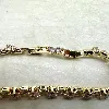 bracelet rivière serti d'oxydes en acier doré l16 /19 cm