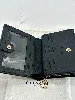 portefeuille coach à bouton pression en cuir noir