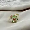 bague ouverte à motif floral ornée d’oxydes, en métal doré