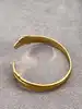 bracelet jonc ouvert motif feuille en métal doré