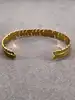 bracelet jonc ouvert motif feuille en métal doré