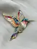 broche en émail bleu et orange motif colibri