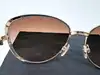 lunettes de soleil chanel camélia 4187 c.395/3b monture en métal doré et acétate écaille, verres marron dégradé