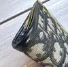 porte-monnaie christian dior vintage en toile oblique avec un fermoir clip doré