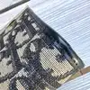 porte-monnaie christian dior vintage en toile oblique avec un fermoir clip doré
