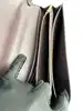 sac pochette coach en cuir grainé noir, chîne dorée détachable