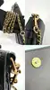 sac pochette coach en cuir grainé noir, chîne dorée détachable
