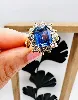 bague marguerite vermeille centrée d'une pierre bleue taille émeraude et 12 oxydes argent 925 millième (22 ct) 6,45g