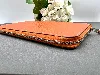 portefeuille hermès silk'in classique en cuir orange et doublure en twill de soie imprimé